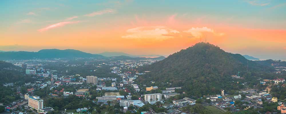 Aerial view of Bangkok city skyline at sunset, showing urban development