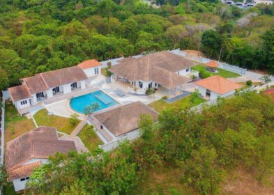 Expansive 10-bedroom villa estate near Nai Harn with multiple buildings, pool, and tropical garden