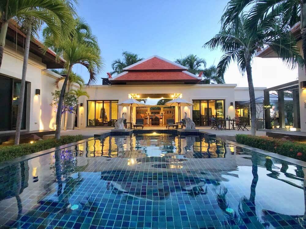 Exquisite 5-bed, 5-bath pool villa near Nai Harn Beach with 1,548 sqm land and 320 sqm build. Features 5 private pavilions, saltwater pool with jacuzzi, tropical landscaping, outdoor kitchen, and high-end finishes.