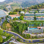 Aerial view of luxury waterfront villas in Phuket, showcasing high-end real estate development with modern infrastructure and lush tropical surrounding