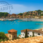 View of Mallorca coastline and marina with “US Tariffs” stamp overlaid in the sky – cover image for article on the economic impact of US trade policy on the Mallorca property market