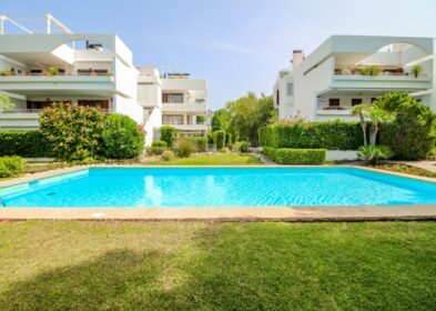 Communal pool and apartment buildings at Bellresguard residential complex in Mallorca