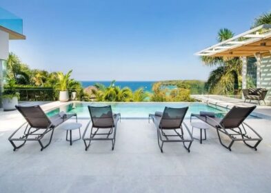 4-Bed Luxury villa for Sale in Surin, Phuket - Build Area 745 sqm Villa for Sale Surin, Phuket, Thailand See map € 2,697,541 4 4 Bedrooms 5 5 Bathrooms 484 sqm Plot Size 745 sqm Built-up Area Villa Property Type REF ID: psv-sur-1627 Property Features Villa / Houses4 bed5 bathAir ConditioningPoolThe Land area is 484 sqmThe built up area is 745 sqmSecure ParkingBalconyDeck Full Description Overview This resale 4-bedroom sea view pool villa in Surin, Phuket enjoys breathtaking views across the Andaman Sea towards the iconic Amanpuri Resort. Tastefully designed, the villa pairs contemporary furnishings with a refined neutral palette accented by soft furnishings, artwork, and decorative pieces. Expansive glazing and open-plan living spaces maximise natural light while framing panoramic ocean views from multiple areas of the home. Offered at US$3.2 million or the equivalent in Thai Baht, this modern contemporary residence is within walking distance of Surin Beach, one of Phuket’s most prestigious west coast locations. Layout The villa is set on a generous 484 sqm plot with a built-up area of 745 sqm arranged across 2 levels. There are 4 spacious bedrooms with ensuite bathrooms, 2 on the main level and 2 on the upper floor. Key features include a 10-metre infinity pool, a massage room, and a large viewing deck overlooking the coastline and the Andaman Sea. Development Overview Developed by a private luxury villa developer responsible for 2 other premier residential developments in Phuket. The estate is an exclusive hillside collection of just 9 luxury sea view villas with 3-11 bedrooms. Location Located on a hillside directly across the road from Surin Beach, the villa is within a 450-metre walk to the beach. Within a 5 to 15 minute drive are Cafe del Mar, Boat Avenue, Laguna, upscale dining venues, beach clubs, and a wide range of lifestyle amenities. Patong is 23 minutes away, while Phuket International Airport is around 20 km or approximately a 45 minute drive. For a broader look at the area, view Surin property for sale. You may also want to explore Surin villas for sale. Property Features * Villa / Houses * 4 bed * 5 bath * Air Conditioning * Pool * 484 sqm * 745 sqm * Secure Parking * Balcony * Deck * Outdoor Entertaining * Freehold (Thai Company) * Fully Furnished * Gated Community * Large Pool * Massage Room / Facilities * Near Beach * Private Pool * Resale * Sea View * Seafront / Seaside