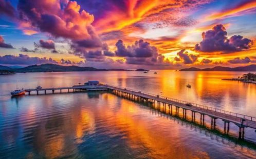 Breathtaking sunrise over Chalong Pier in Phuket, Thailand, with colorful skies reflecting on the calm ocean waters