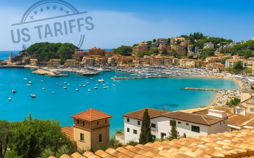 View of Mallorca coastline and marina with “US Tariffs” stamp overlaid in the sky – cover image for article on the economic impact of US trade policy on the Mallorca property market